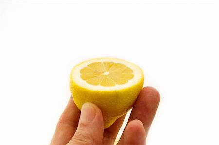 simsearch:400-08814206,k - fresh ripe lemon cutted in half hold in hand closedup Photographie de stock - Aubaine LD & Abonnement, Code: 400-06178579
