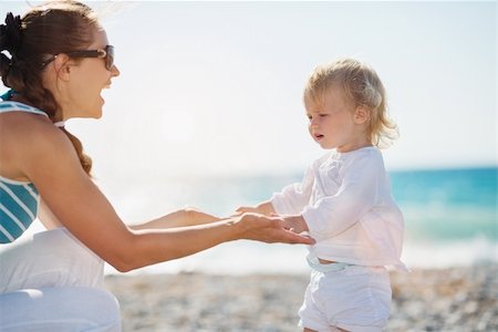 Mother and baby holding hands on beach Stock Photo - Budget Royalty-Free & Subscription, Code: 400-06178674