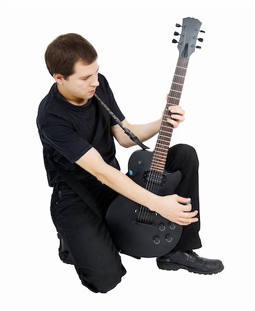 young singer, dressed in black with an electric guitar on white background Foto de stock - Super Valor sin royalties y Suscripción, Código: 400-06178884