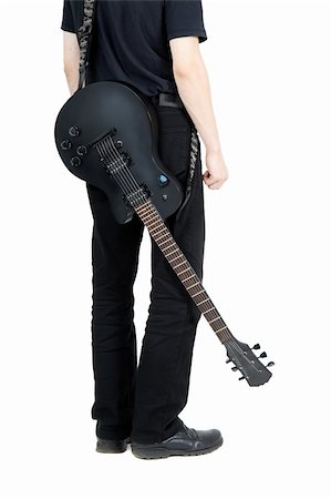 rocker guitarist - performer with an electric guitar in black. View from the back Stock Photo - Budget Royalty-Free & Subscription, Code: 400-06178906