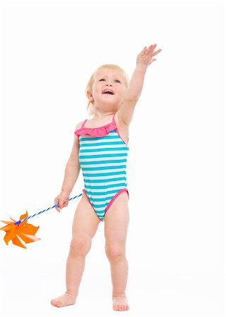 Happy baby in swimsuit with pinwheel pointing up Stock Photo - Budget Royalty-Free & Subscription, Code: 400-06179224