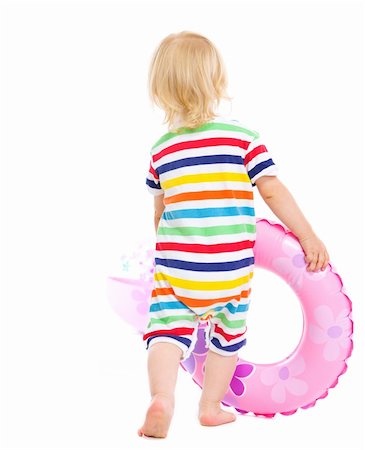 simsearch:400-04766687,k - Baby in swimsuit playing with inflatable ring and beach ball. Rear view Foto de stock - Super Valor sin royalties y Suscripción, Código: 400-06179239