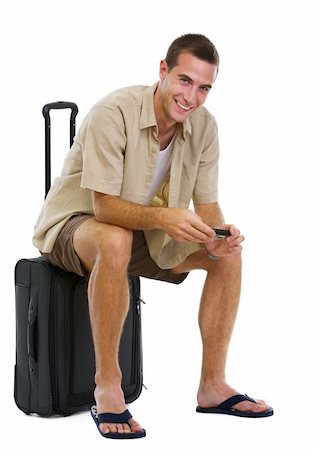 simsearch:400-07633149,k - Happy tourist sitting on wheels bag and waiting for airplane Stock Photo - Budget Royalty-Free & Subscription, Code: 400-06179298