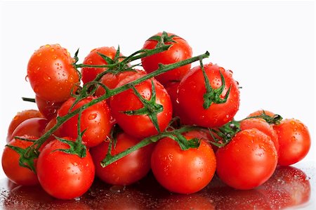 Tomatoes in trusses on a white background Foto de stock - Royalty-Free Super Valor e Assinatura, Número: 400-06170439