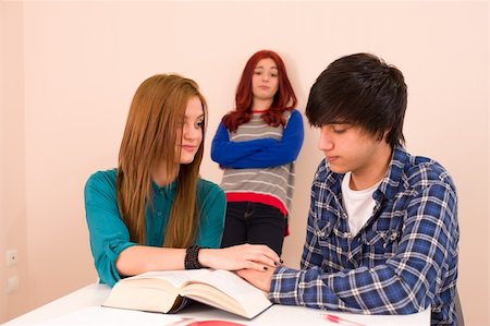 Students in classroom, jealous girl looking at a couple Stock Photo - Budget Royalty-Free & Subscription, Code: 400-06172674