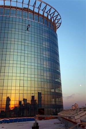simsearch:400-04949609,k - Rock climber hanging on rope attached to roof of high building at sunset Stock Photo - Budget Royalty-Free & Subscription, Code: 400-06173958