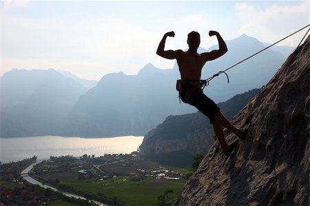 Silhouette of a rock climber flexing biceps, near Arco, North-Ialy Stock Photo - Budget Royalty-Free & Subscription, Code: 400-06173991