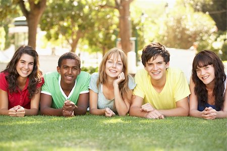 Group Of Teenagers Lying On Stomachs In Park Stock Photo - Budget Royalty-Free & Subscription, Code: 400-06204101