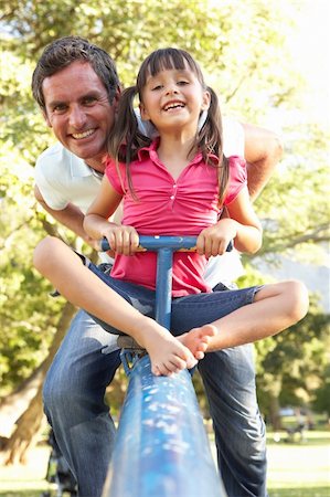 dad with kid on playground - Father And Daughter Riding On See Saw In Playground Stock Photo - Budget Royalty-Free & Subscription, Code: 400-06204271