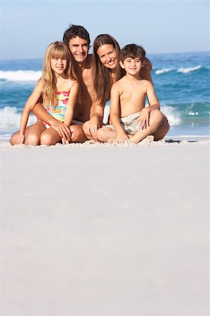 seven year old girls swimsuit - Young Family Relaxing On Beach Holiday Stock Photo - Budget Royalty-Free & Subscription, Code: 400-06204497