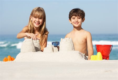 Children Building Sandcastles On Beach Holiday Stock Photo - Budget Royalty-Free & Subscription, Code: 400-06204528