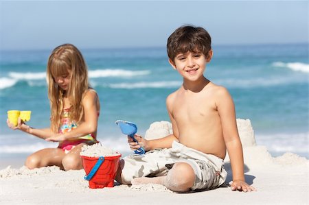 seven year old girls swimsuit - Children Building Sandcastles On Beach Holiday Stock Photo - Budget Royalty-Free & Subscription, Code: 400-06204538