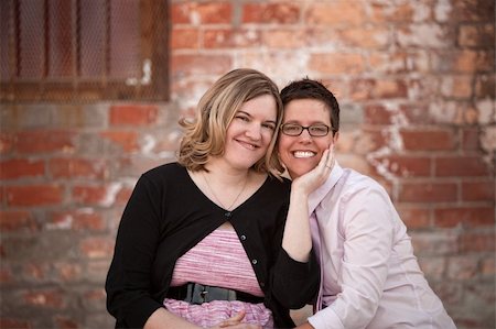 Lesbian couple sitting next to each other outdoors Stock Photo - Budget Royalty-Free & Subscription, Code: 400-06204573