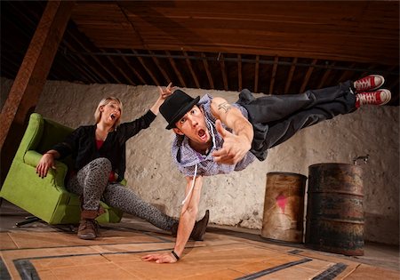 Handsome Latino break dancer in mid air with cheering friend Stock Photo - Budget Royalty-Free & Subscription, Code: 400-06204594