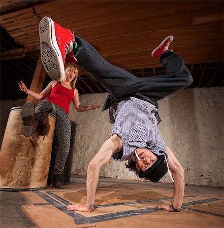 Flexible young Mexican break dancer with impressed friend Stock Photo - Budget Royalty-Free & Subscription, Code: 400-06204599