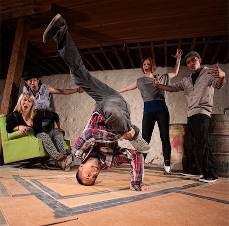 Latino man spinning on his head in break dancing battle Stock Photo - Budget Royalty-Free & Subscription, Code: 400-06204593