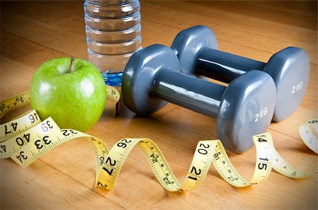 simsearch:400-08532856,k - Pair of dumbbells, green apple, measuring tape and bottle of water. Exercise and healthy diet concept. Stock Photo - Budget Royalty-Free & Subscription, Code: 400-06204710