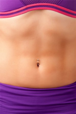 Closeup of a fit woman's abs with a pierced belly button Stock Photo - Budget Royalty-Free & Subscription, Code: 400-06204732