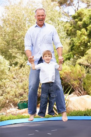 Father And Son Jumping On Trampoline In Garden Stock Photo - Budget Royalty-Free & Subscription, Code: 400-06205102