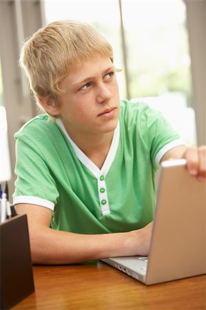 simsearch:400-04044137,k - Guilty Looking Teenage Boy Using Laptop At Home Stock Photo - Budget Royalty-Free & Subscription, Code: 400-06205137