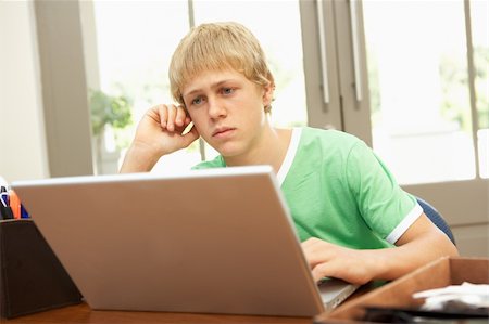 simsearch:400-04044137,k - Worried Looking Teenage Boy Using Laptop At Home Stock Photo - Budget Royalty-Free & Subscription, Code: 400-06205154