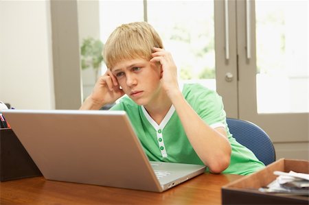 simsearch:400-04044137,k - Worried Looking Teenage Boy Using Laptop At Home Stock Photo - Budget Royalty-Free & Subscription, Code: 400-06205155