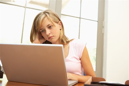 simsearch:400-04044137,k - Worried Looking Teenage Girl Using Laptop At Home Stock Photo - Budget Royalty-Free & Subscription, Code: 400-06205153