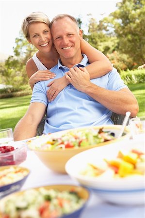 Couple Enjoying Meal In Garden Stock Photo - Budget Royalty-Free & Subscription, Code: 400-06205197