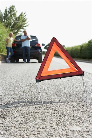 Couple Broken Down On Country Road With Hazard Warning Sign In Foreground Stock Photo - Budget Royalty-Free & Subscription, Code: 400-06205208