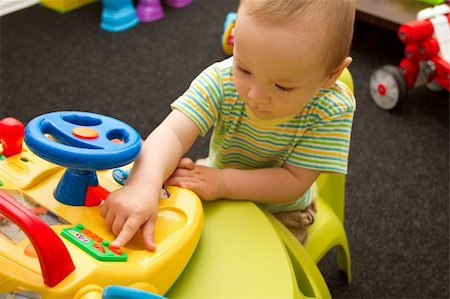 Cute baby boy playing with the toys in playroom Stock Photo - Budget Royalty-Free & Subscription, Code: 400-06205591