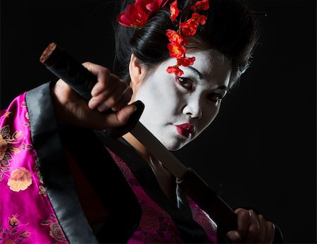 Portrait of geisha pulls out sword of sheath on black Photographie de stock - Aubaine LD & Abonnement, Code: 400-06207746