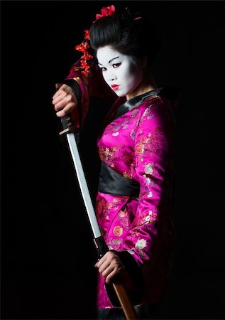 Portrait of geisha warrior pulls out sword of sheath on black Stock Photo - Budget Royalty-Free & Subscription, Code: 400-06207749