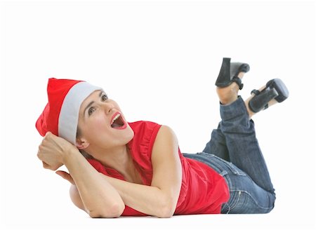 santa christmas hat women - Happy woman in Christmas hat laying on floor and looking on copy space Stock Photo - Budget Royalty-Free & Subscription, Code: 400-06208273