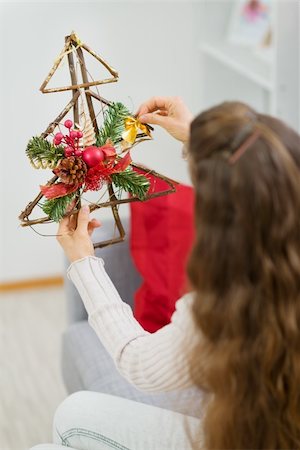 Woman holding Christmas decoration tree. Rear view Stock Photo - Budget Royalty-Free & Subscription, Code: 400-06208340