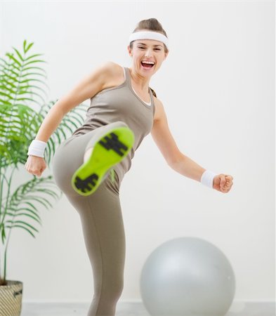 funny wellness healthcare - Happy fitness woman kicking in camera Stock Photo - Budget Royalty-Free & Subscription, Code: 400-06208478