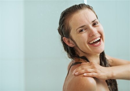 Portrait of happy woman taking shower Stock Photo - Budget Royalty-Free & Subscription, Code: 400-06208534