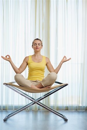 Young woman meditating on modern chair Stock Photo - Budget Royalty-Free & Subscription, Code: 400-06208539