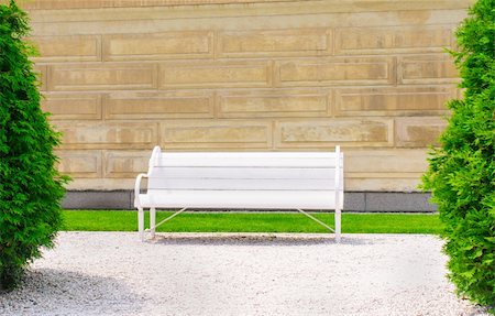 Empty wooden bench on the wall backgroundon a sunny day Stock Photo - Budget Royalty-Free & Subscription, Code: 400-06201094