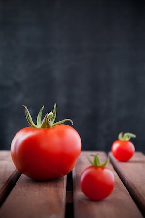 Some tomatoes on old wood table background Stock Photo - Budget Royalty-Free & Subscription, Code: 400-06201589