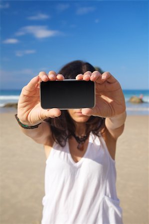 simsearch:400-05918503,k - smart phone in woman hand on a beach in Asturias Spain Photographie de stock - Aubaine LD & Abonnement, Code: 400-06201873