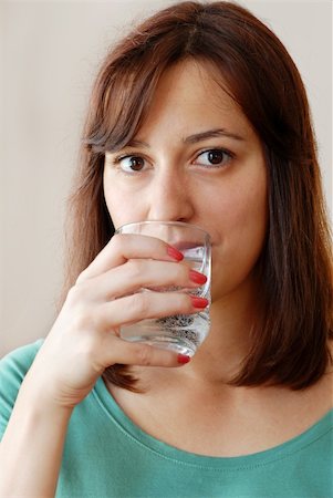 fresh spring drinking water - portrait of young caucasian brunette woman with glass in hand drinking water Stock Photo - Budget Royalty-Free & Subscription, Code: 400-06202529