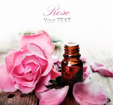 rose essential oil - Essential oil with rose petals on wooden background Stock Photo - Budget Royalty-Free & Subscription, Code: 400-06202605