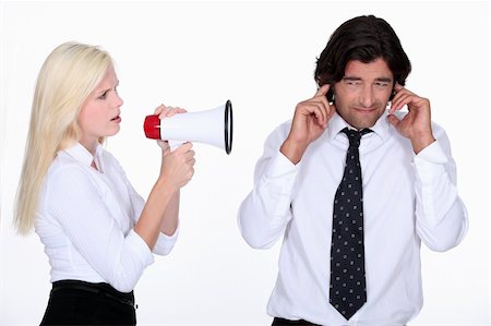 woman talking through a megaphone and a man plugging his ears Stock Photo - Budget Royalty-Free & Subscription, Code: 400-06202963