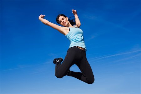 simsearch:400-04215852,k - Attractive happy young woman jumping - sky background Stock Photo - Budget Royalty-Free & Subscription, Code: 400-06203032