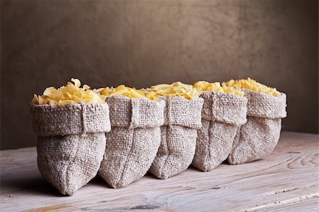 row of sacks - Assortment of five pastas in burlap sacks on old wooden table Stock Photo - Budget Royalty-Free & Subscription, Code: 400-06203080