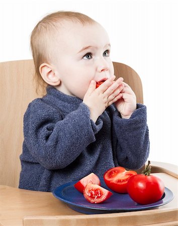young child eating in high chair isolated in white backgound Foto de stock - Royalty-Free Super Valor e Assinatura, Número: 400-06203112