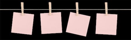 simsearch:400-06203504,k - Four blank pink sticky notes held on a string by pegs isolated on a black background. Stock Photo - Budget Royalty-Free & Subscription, Code: 400-06203500