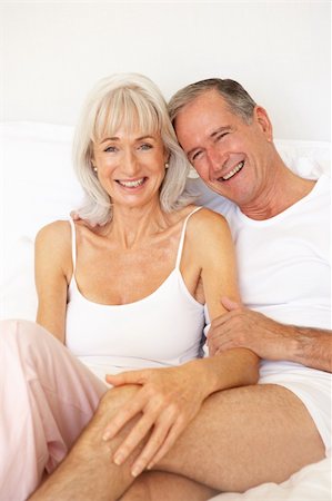 Senior Couple Relaxing On Bed Stock Photo - Budget Royalty-Free & Subscription, Code: 400-06203563