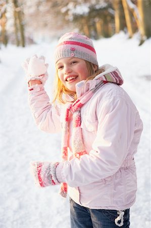 Girl About To Throw Snowball In Snowy Woodland Stock Photo - Budget Royalty-Free & Subscription, Code: 400-06203607