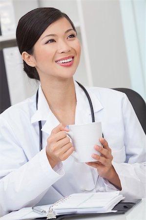 doctors coffee - A Chinese Asian female medical doctor drinking tea or coffee in a hospital office Stock Photo - Budget Royalty-Free & Subscription, Code: 400-06203887